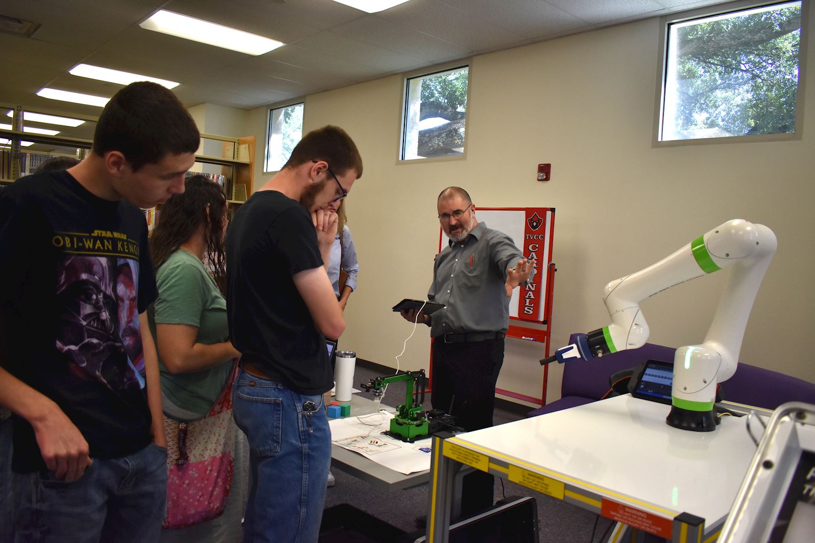 Automation Training instructor Ronn Herod explains the program and robotics to interested students.                                         