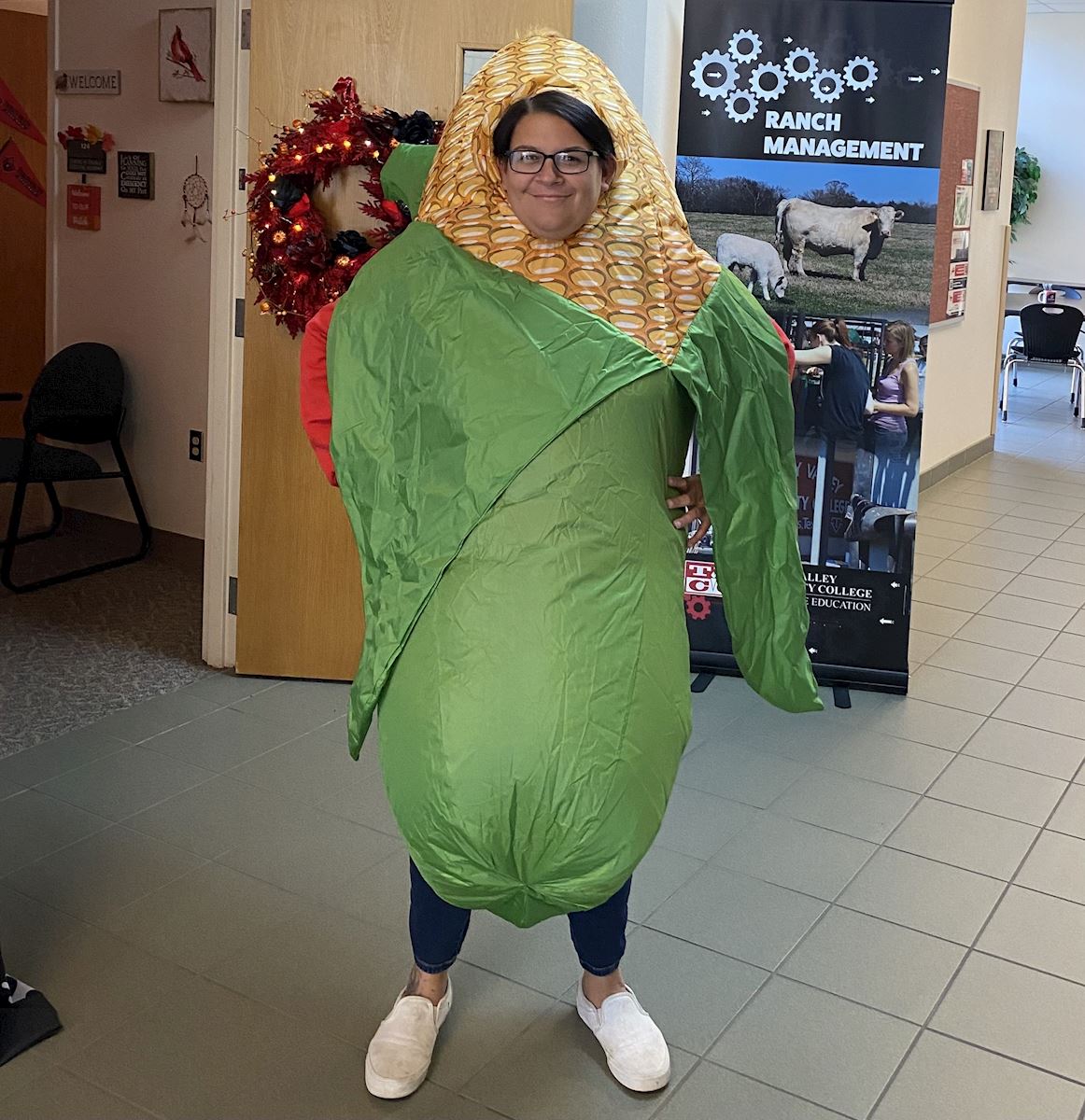 Professor Tyler Hebert poses in her costume as a corn on the cob.                                                                           