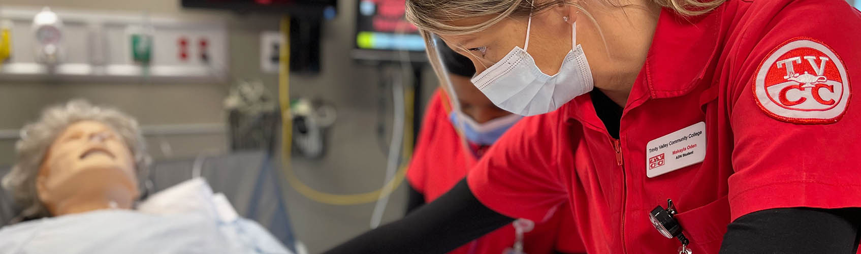 Woman nursing student working on simulated patient