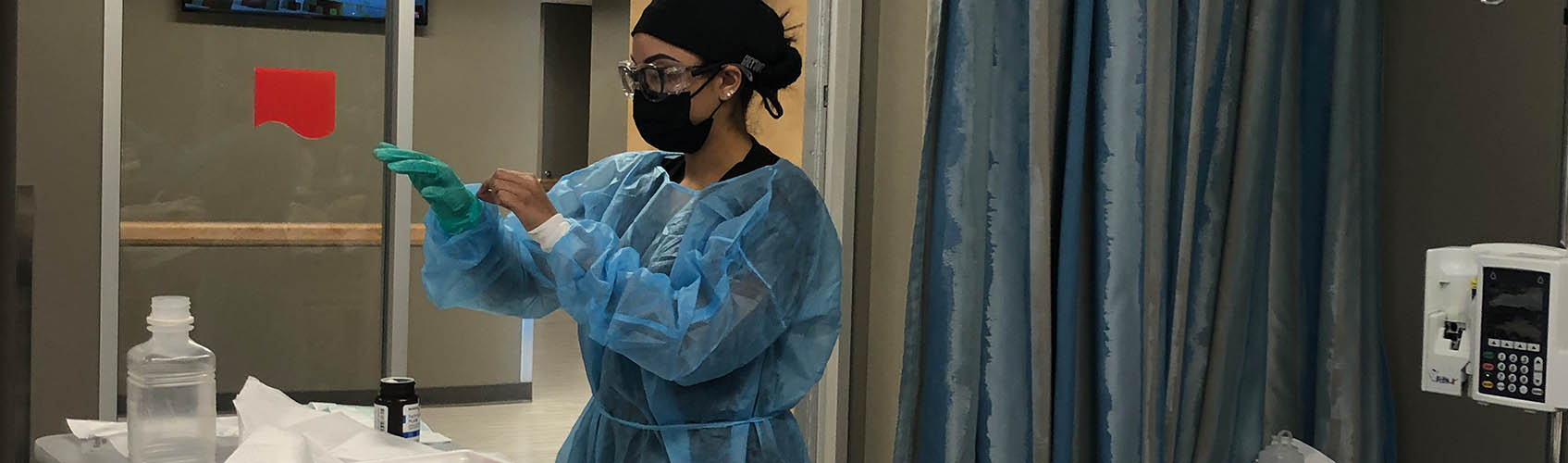 Woman nursing student working on simulated patient